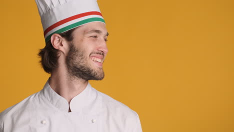 caucasian man in front of camera on yellow background.