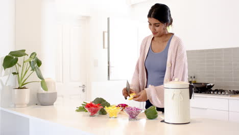 indian woman chopping vegetables in modern kitchen, preparing healthy meal