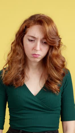 a red-haired woman expressing sadness and distress, with open and closed eyes