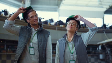 livestock workers posing automated carousel portrait. hard working day end.