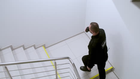 Man-in-uniform-going-upstairs