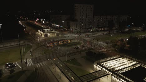 the tram leaves the depot while the other cars wait for the green light at the intersection