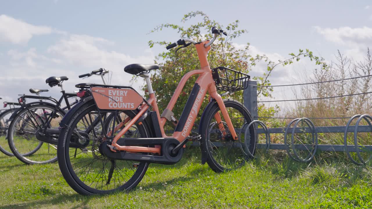 Parked eco friendly electric bicycle at outdoor park rack, Copenhagen