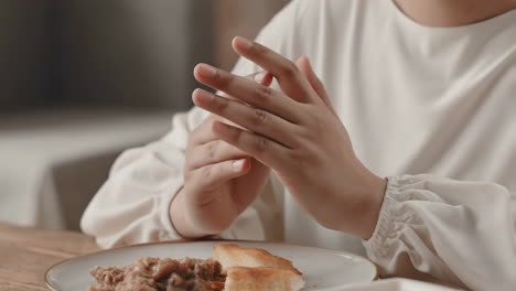person praying before meal