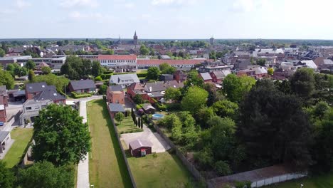 Aerial above small town in Belgium, scenic landscape view of city center of Lommel during a cloudy day.