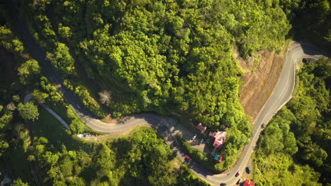 coches circulando por una carretera sinuosa en un valle tropical en costa rica