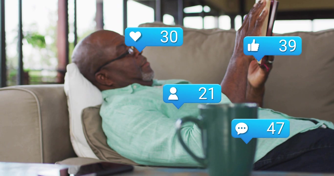 Senior man reading book as comment icon appearing boosting social media engagement around mug