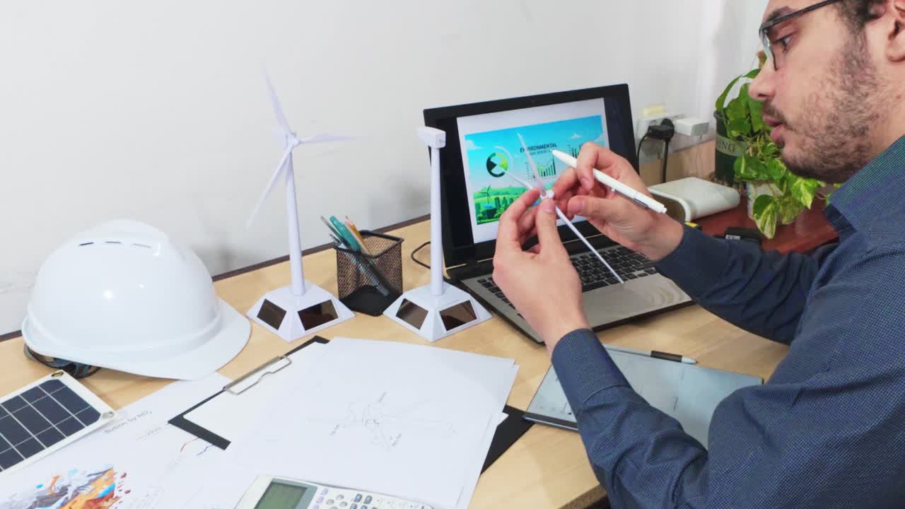 Engineer Explaining the Design of a Wind Turbine Blade