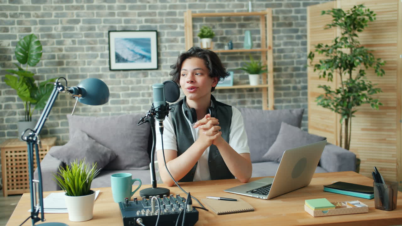 Young podcaster recording a podcast at home