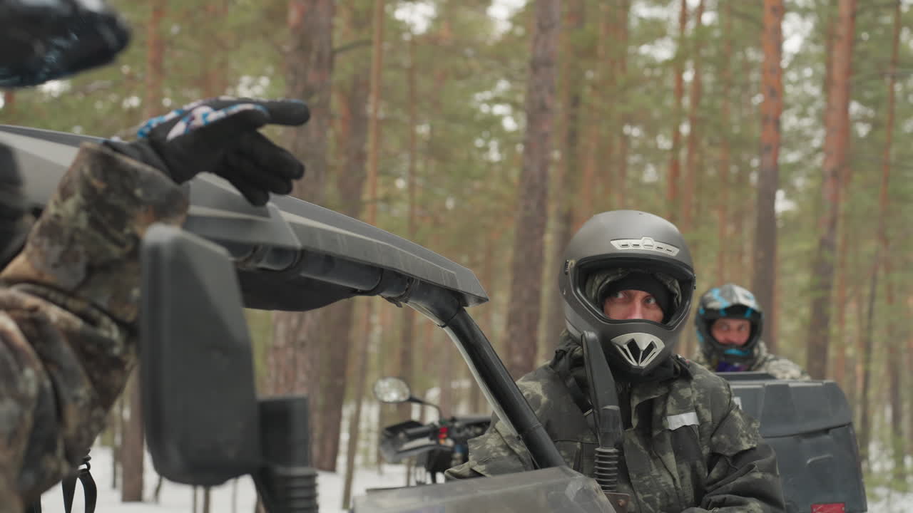 Motorcyclists navigating winter. Bikers discussing path amidst winter landscape. Group of motorcyclists communicating and strategizing during winter ride through dense snowy pine forest