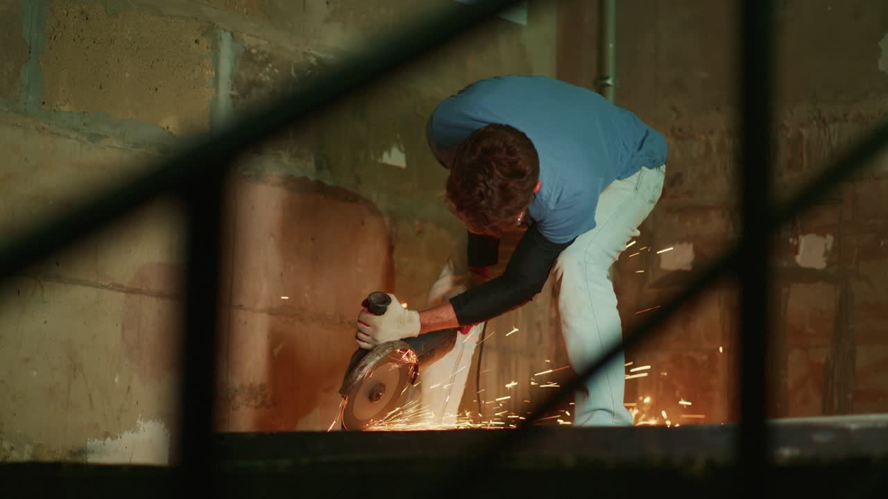 Man Cutting Metal with Angle Grinder Creating Bright Sparks