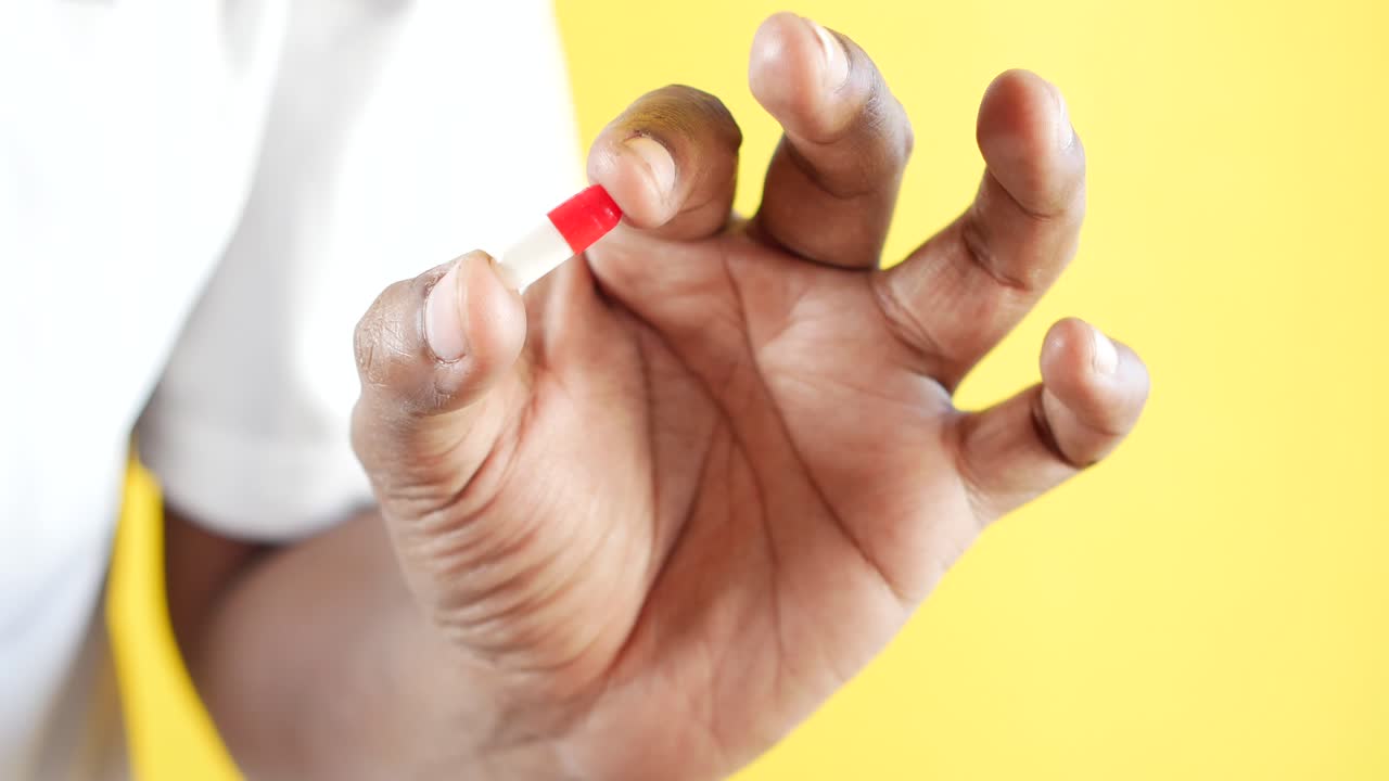 Close up of man hand holding a medical capsule ,