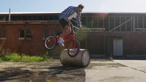 BMX-rider-doing-trick-in-an-empty-yard