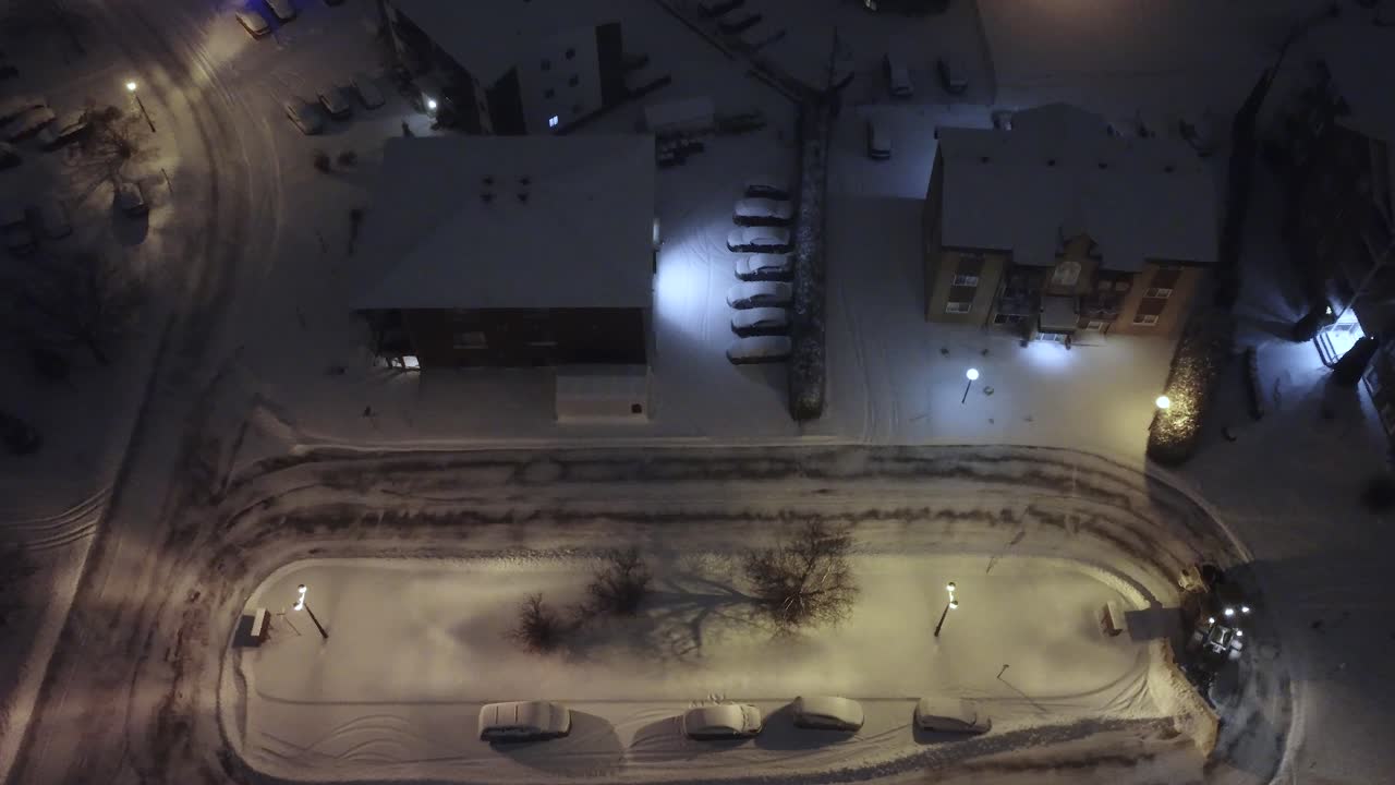 Tractor snow plowing suburb area in Canada after heavy snow storm, aerial view