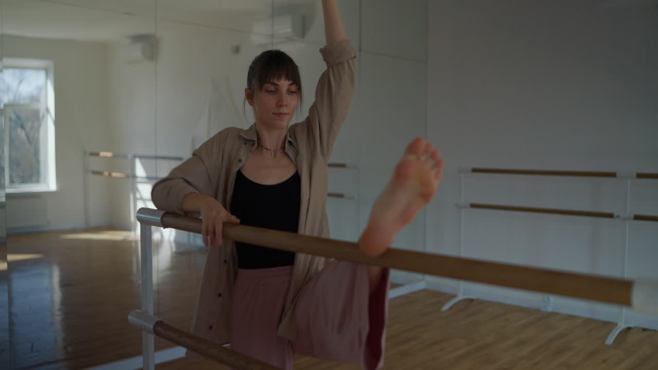 Ballet dancer stretching at the barre