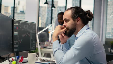 investment consultant talking in telephone call with client, reviewing portfolio