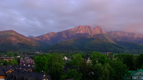 Landscape-of-the-legendary-Giewont-peak-in-the-Polish-Tatry-Mountains,-farmland,-forests-near-Zakopane,-Poland,-a-resort-town-with-traditional-Goral-architecture