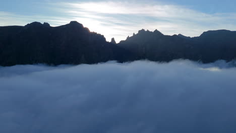 Madeiras-mountaintops-and-morning-mist-clouds-in-sunny-panoramic-drone-view