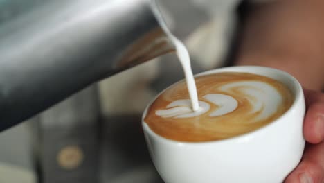 barista making of cafe latte art, heart shape