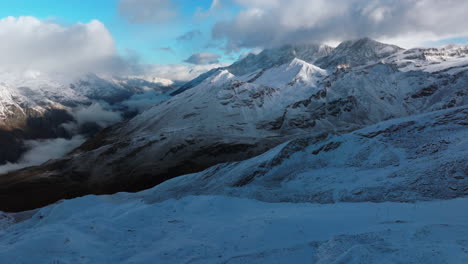 Sunset-Gornergrat-Zermatt-Glacier-ice-crevasse-river-Swiss-Alps-top-The-Matterhorn-summit-ski-resort-landscape-scenery-aerial-drone-autumn-Railway-Switzerland-pan-right-slowly-motion