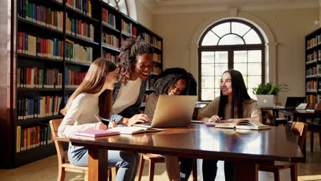 diverse young women collaborating and studying in a university library