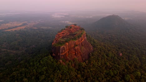 soaring above the misty jungles of sri lanka, this drone clip captures the iconic sigiriya rock at sunrise.