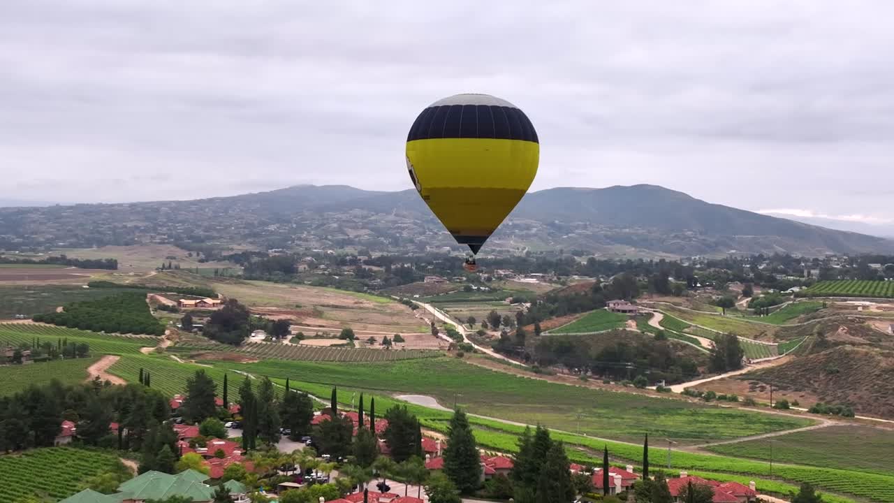 Balão de ar quente voando sobre uma paisagem cênica - visto de outro balão