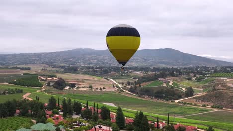 Hot-air-balloon-flying-over-a-scenic-landscape---seen-form-another-balloon