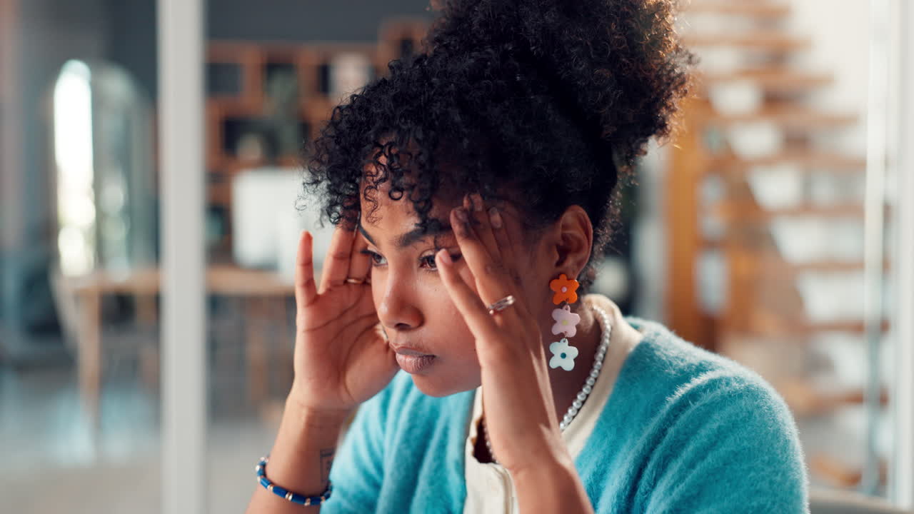 Young Woman Experiencing Stress and Headache in Office