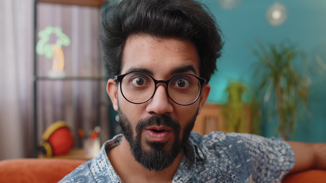 Excited indian man surprised shocked by sudden victory good win news celebrating wow reaction