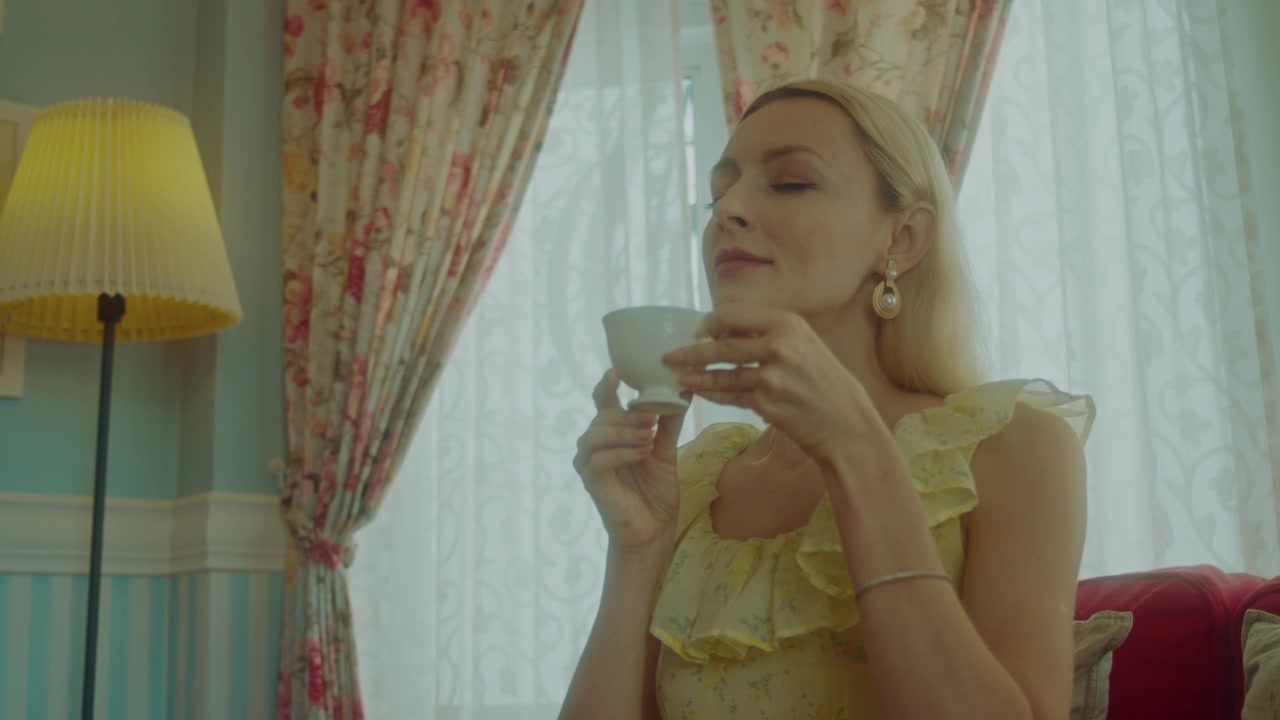 Elegant Woman Drinking Tea in a Cozy Living Room
