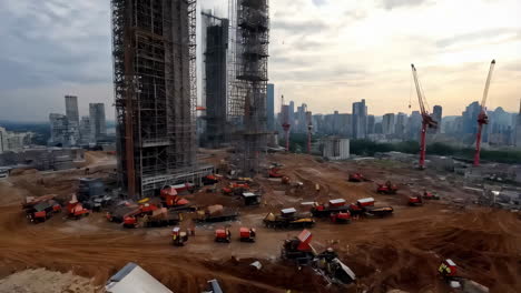 a large construction site with multiple skyscrapers under construction, heavy machinery, and a city skyline in the background