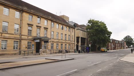 pedestrians walking by a historic building