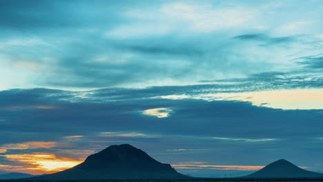 a vibrant cloudscape during sunrise over the mountains of the mojave desert - colorful panning time lapse