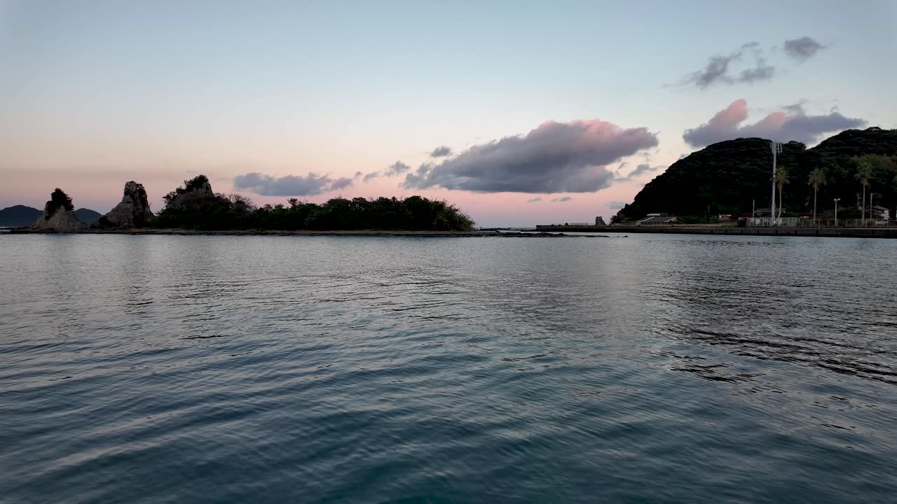 Golden hour sunset over Nachi Bay, Benten Island and Watano Island in background, creating a picturesque seascape in Wakayama Prefecture, Japan