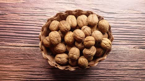 a basket of walnuts on a wooden table