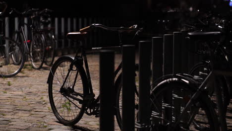 tethered bicycles in downtown copenhagen, denmark at night, close up detail