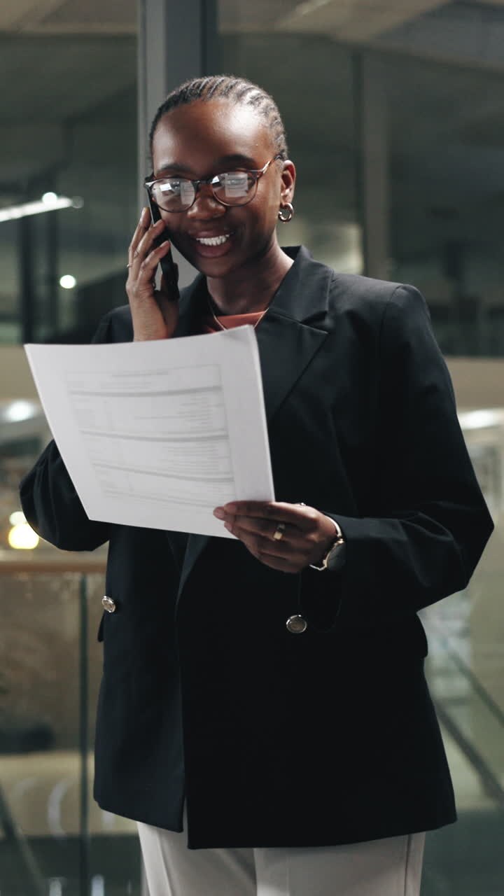 Professional Woman Talking on Phone and Reviewing Documents in Office