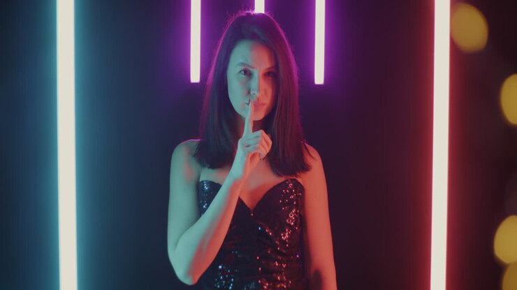 Woman in a sequined dress with neon lights