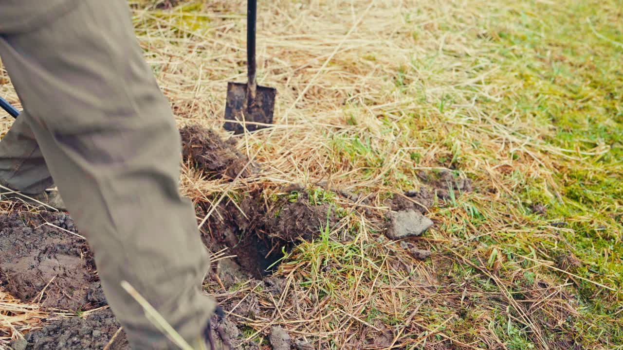 Man Making Holes For Wooden Poles - Constructing Traditional Norwegian Fence - Close Up