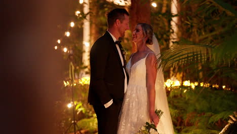 romantic fairy light garden candid happy newly wed bride and groom at wedding, 4k slow motion