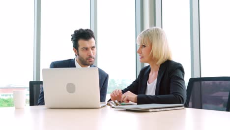 two business people talk project strategy at office