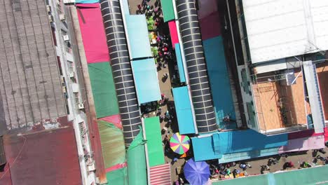 ngau chi wan wet market rooftops, downtown hong kong with fresh meat and fish stalls, top down aerial pass