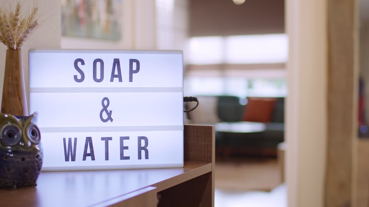Woman walks in and Switches on Decorative Lightbox Written Soap - Water in Comfy and Cozy Home