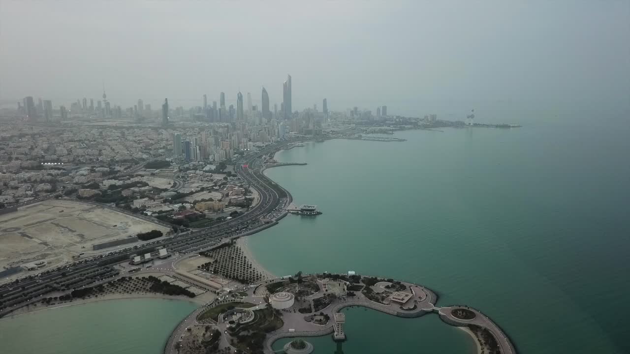 Timelapse Aerial Shot of Kuwait City Skyline. Flying Over the Green Island. Overcast Weather. Forward Dolly