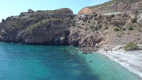 aerial view of a beach with a huge rock in the coast of andalusia