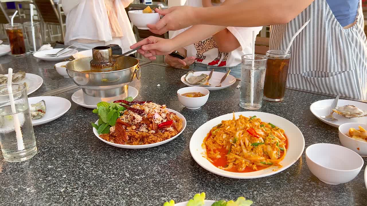People enjoying seafood dishes in Chonburi, Thailand