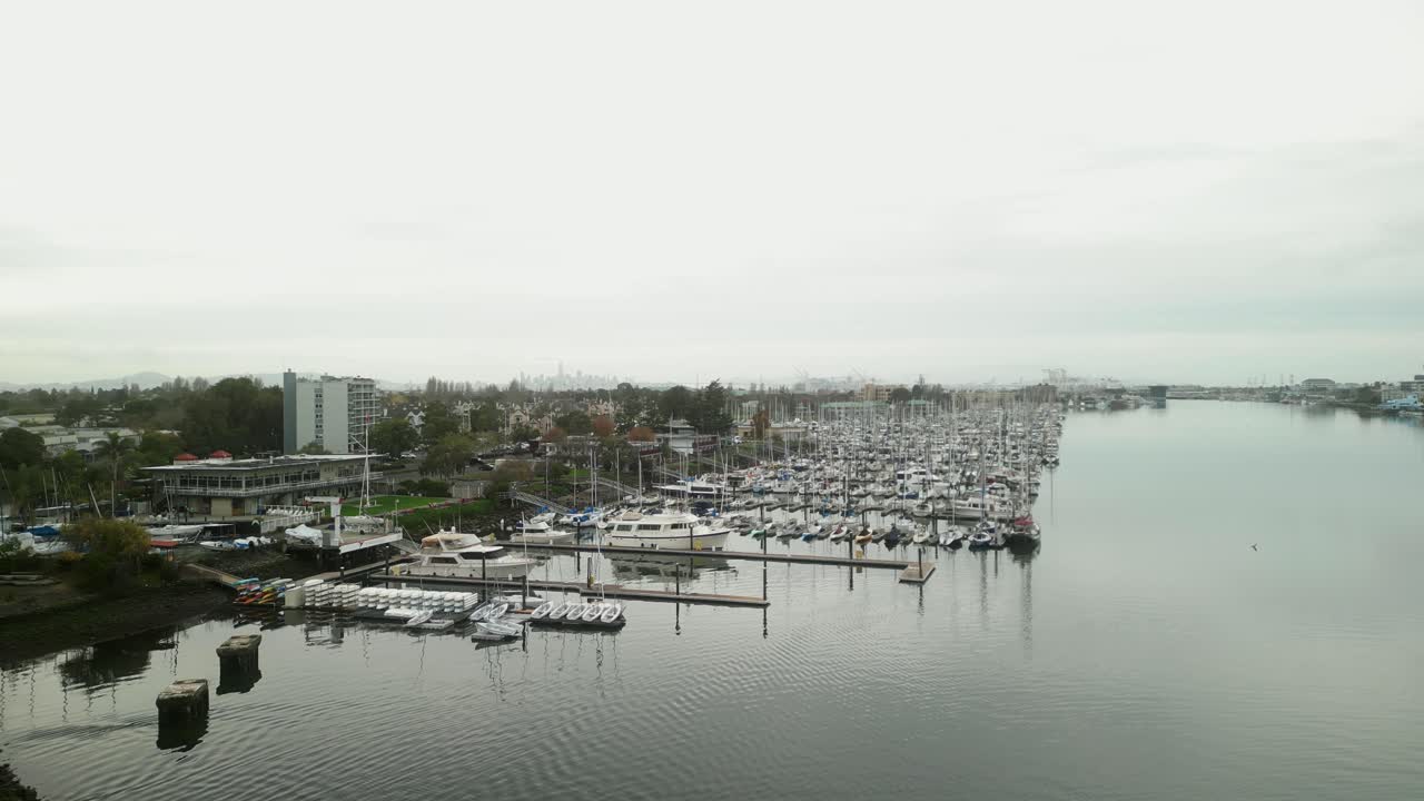 Aerial view of Mariner Square in Alameda, capturing the marina's boat slips, calm waters, and scenic charm under soft California light.