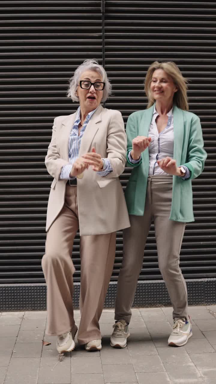 Two Stylish Women Dancing in Business Casual Attire