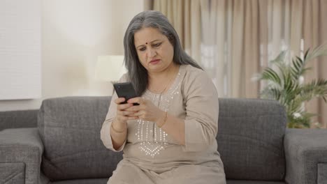 Angry-Indian-old-woman-texting-someone